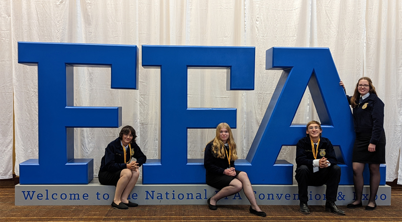 Students with FFA sign