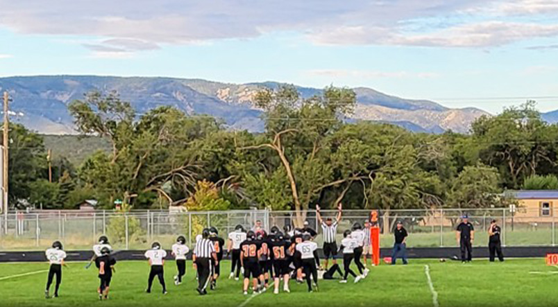 Three football players showing unity on the field