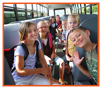Happy elementary school students on a school bus